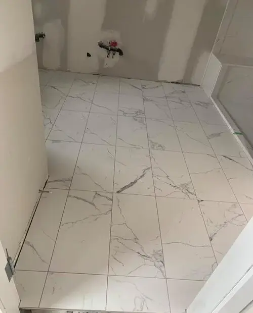 White tiles with black shadow nuances - bathroom installation in process