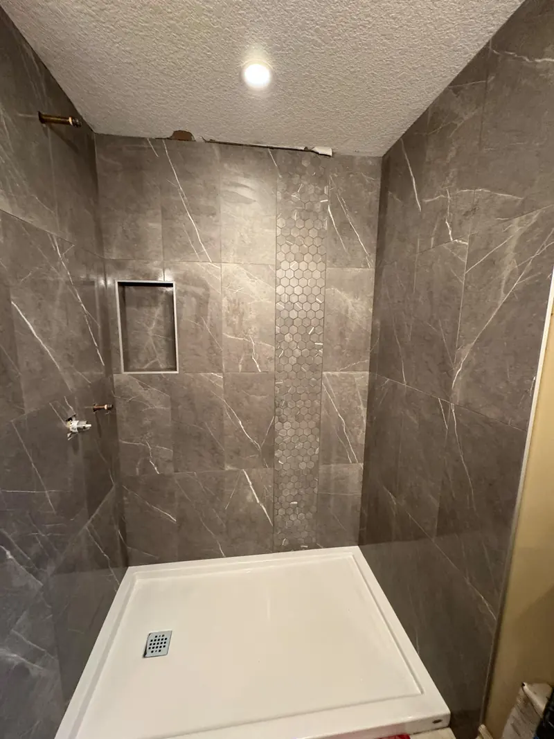 12x24 granite-imitation tile with a vertical hexagon mosaic band insert