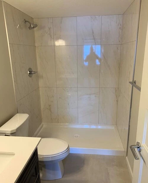 White 24-inch tiles installed at a shower