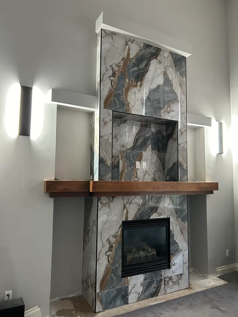 Granite-imitation tile cladding on an interior fireplace and TV stand
