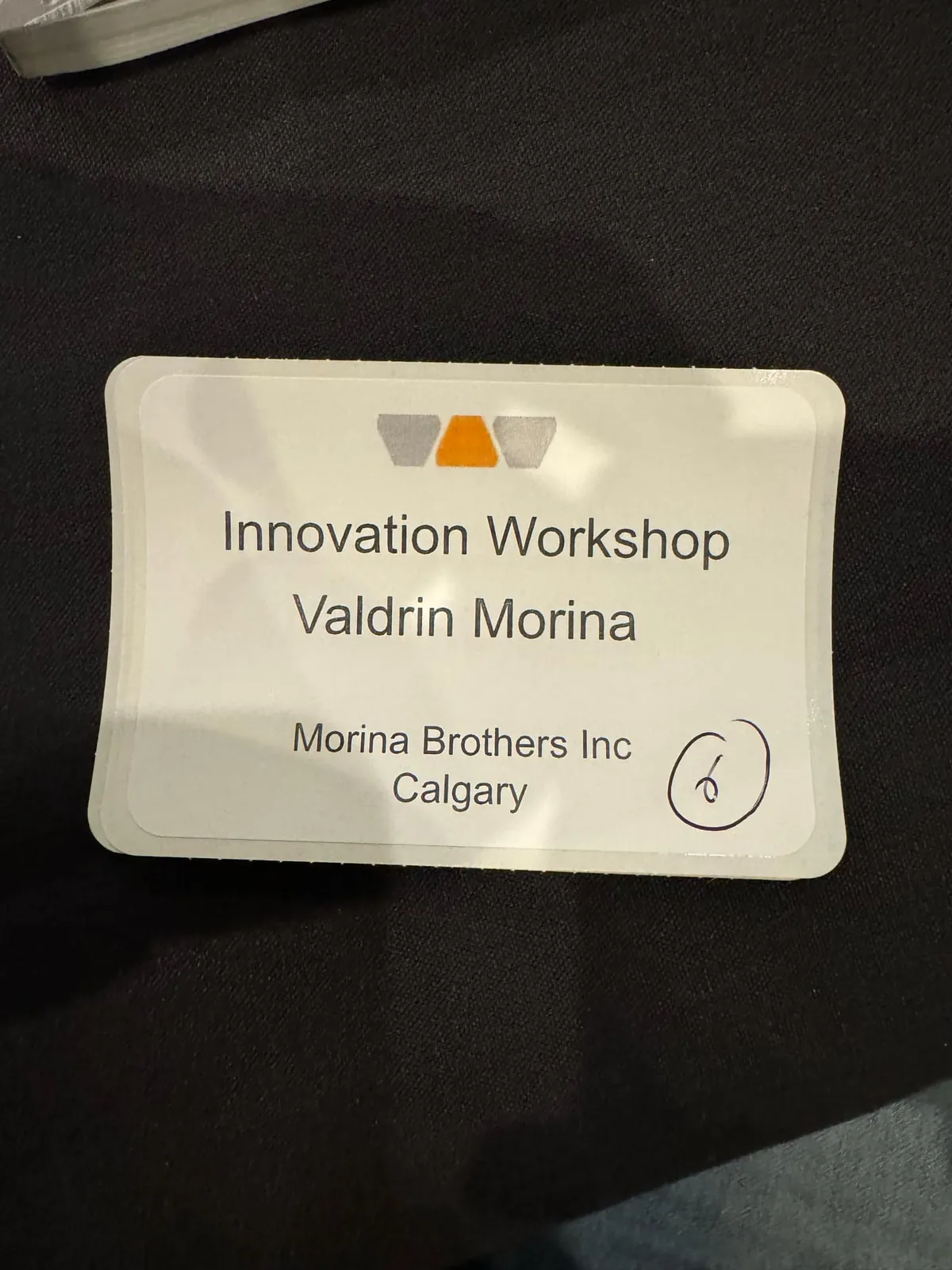 Attendee name badge for Valdrin Morina of Morina Brothers Inc at the Schluter Systems Innovation Workshop in Calgary