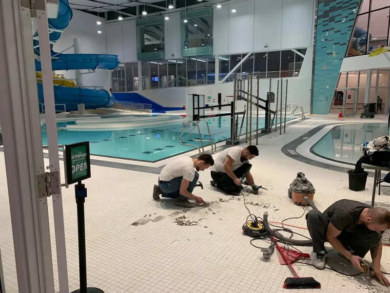 Morina Brothers crew repairing tile floors at a YMCA Calgary location