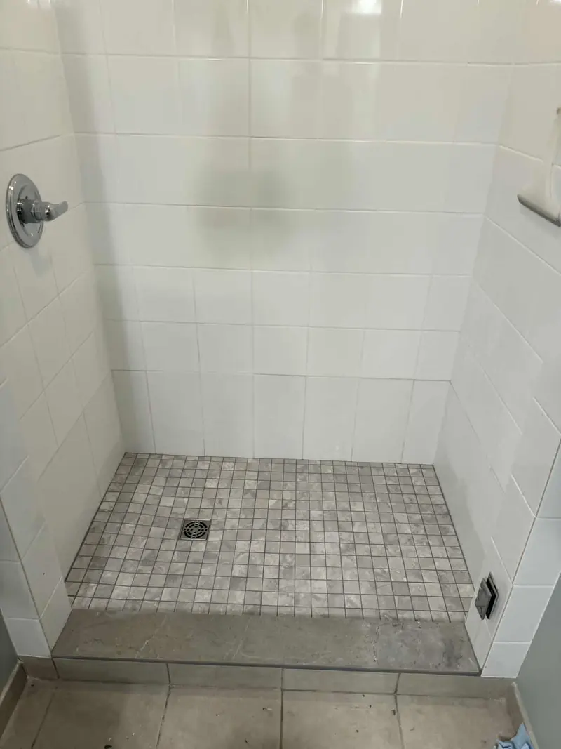 Grey mosaic porcelain marble-imitation tile shower base with sandstone curb