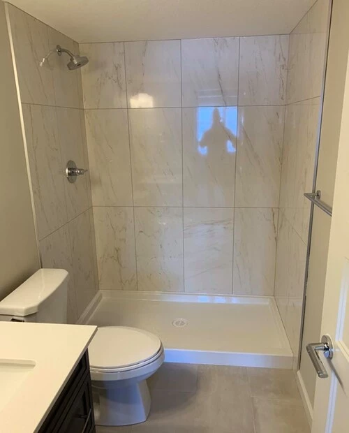 white 24 inch tiles installed at a shower