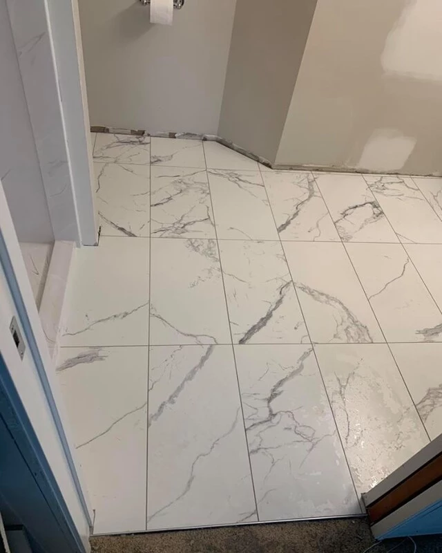 white tiles with black nuances installed in a hallway